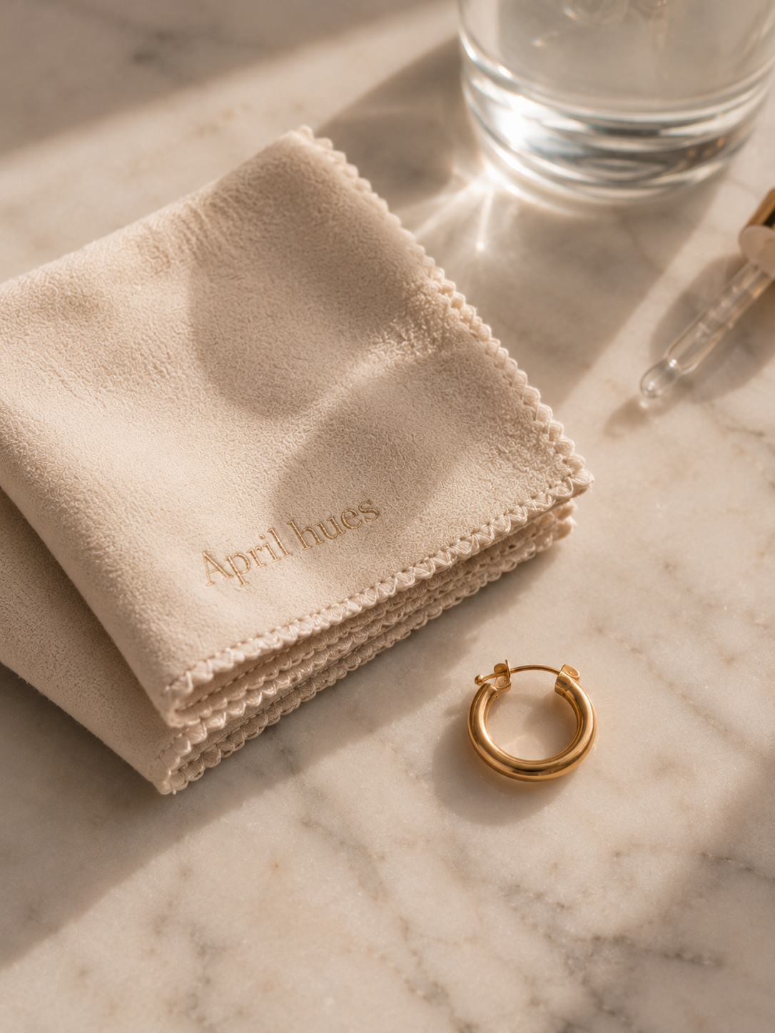 A pair of pearl studs photographed on linen