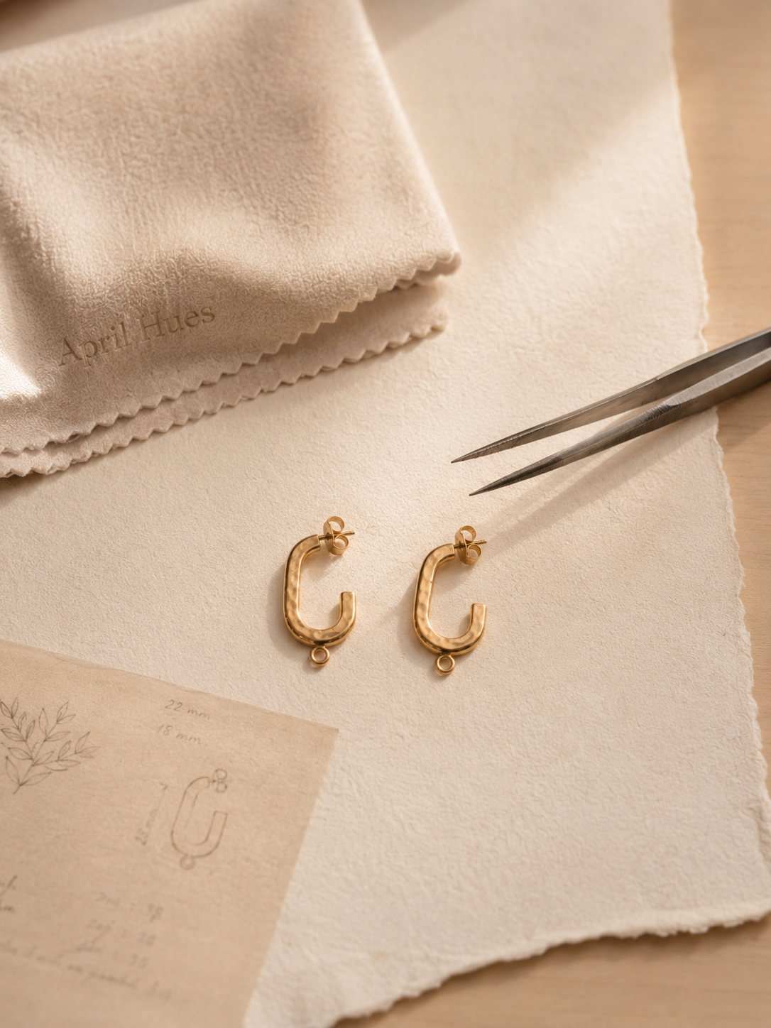 A pair of drop earrings photographed at studio