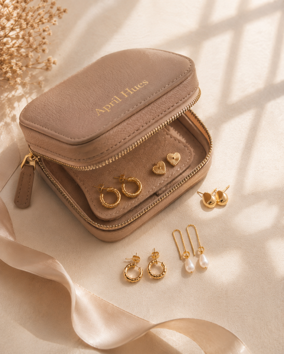 A pair of gold hoops on a textured surface